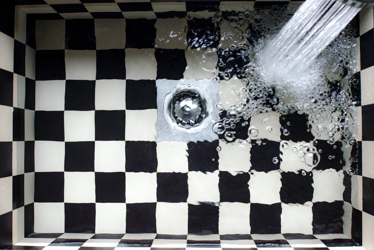 Black and white checkered sink with water in it