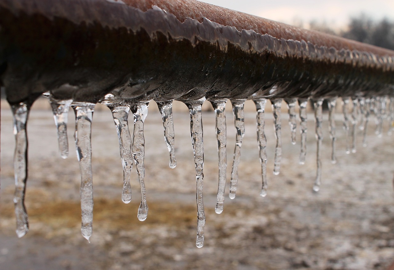 Icicles frozen and dripping on a pipe